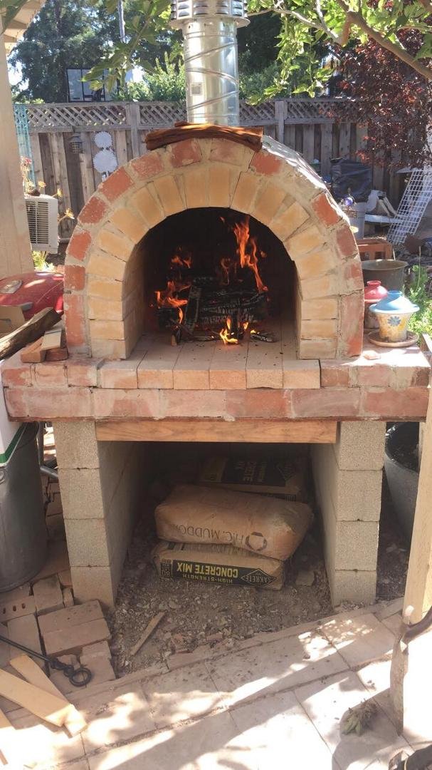 First fire in my new pizza oven I just built. Oven baked pizza in an hour or so. The dough is proofing now.