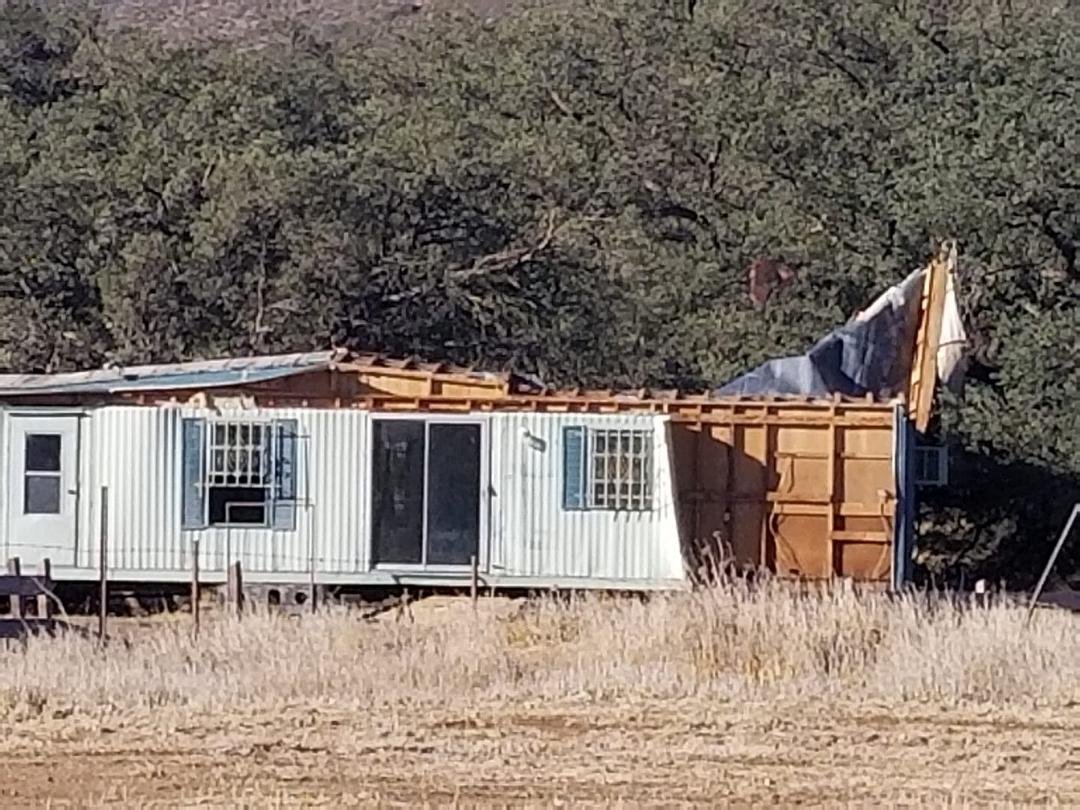 What the winds did to vacant trailer on the property next to ours. There is insulation in the tree.