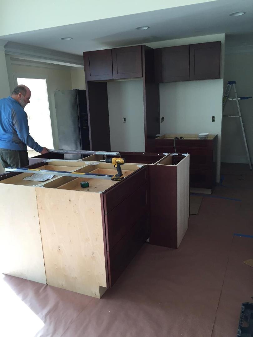 Back side of previous photo, this for fridge n stove, next to Randy is the dishwasher n sink area, then comes the large area of cabinets.
