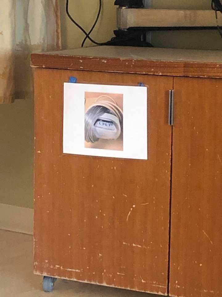 This picture is in my hospital room.  My bad eyesight sees what it’s not.  I know it is a pic telling the staff what is stored in there, but I keep seeing a creature peering out of a blanket or tube with no eyes and a creep