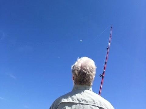 At the beach flying a kite with sister Kate and Bruce, using a fishing pole and 20 lb test line. Are they smart or what?