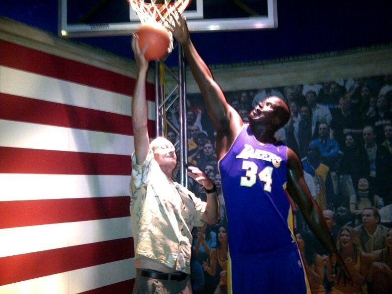 Mark posing with a life-size wax figure of Shaquille O'Neal.