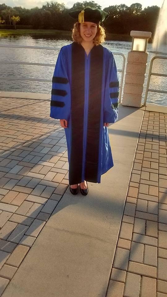 Dr. Hayley Baum pre-graduation picture. Stil waiting for her to get hooded. First the Pharmacy School, now the Dental School in its inaugural year at Bradenton Campus and lastly the Medical School. A long, exciting day and
