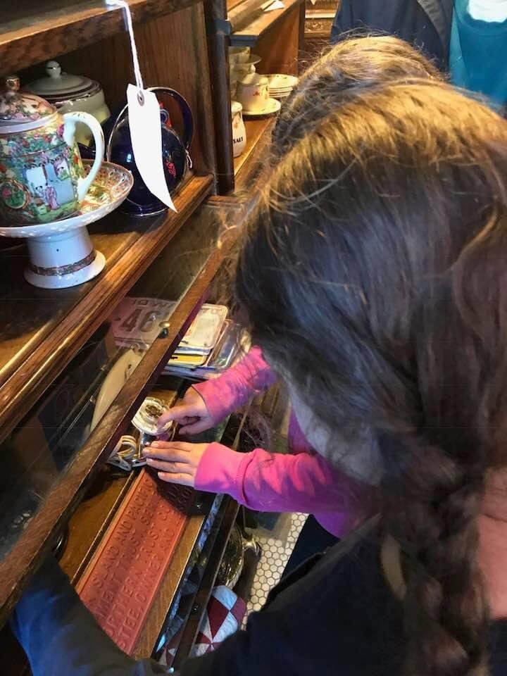 The girls trying to figure out how to work a dial phone