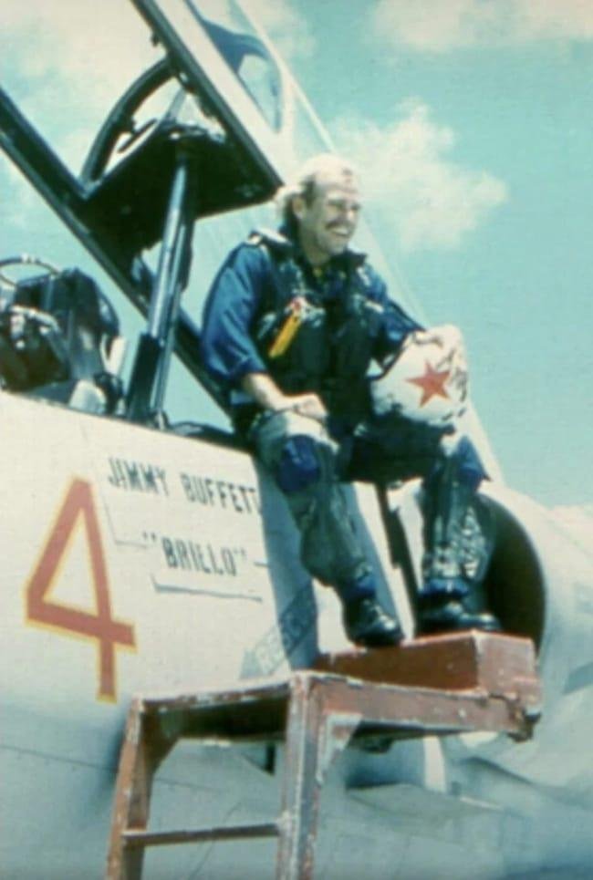 Jimmy Buffet was a pilot who owned many planes over the years. He is shown here with an A-4 Skyhawk light attack aircraft.