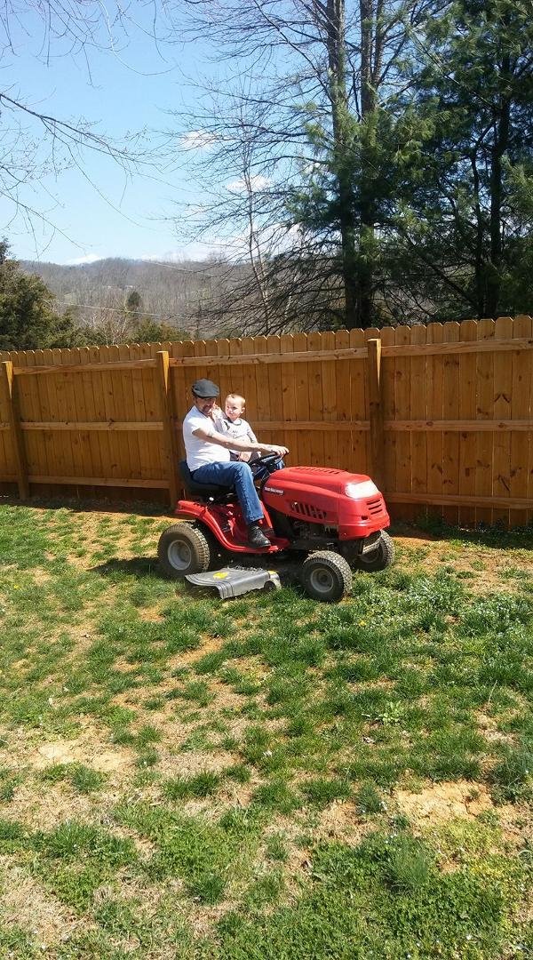 A boy and his papaw mowing