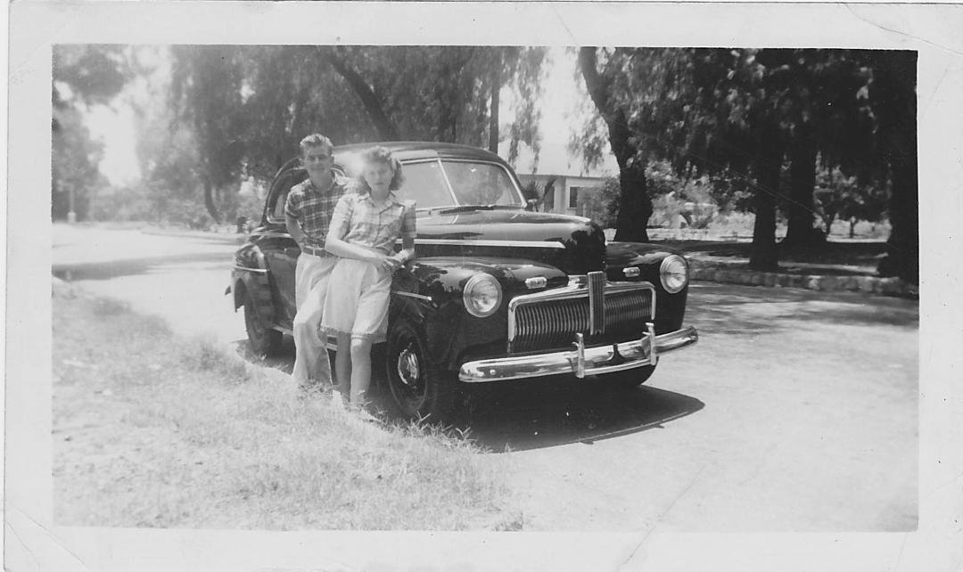 My mom, adding beauty to my dad's car.