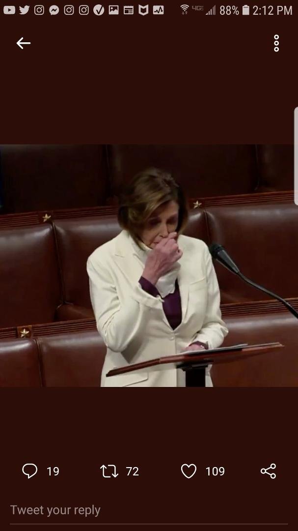 Takes mask off.
Wipes nose.
Puts hand on podium.