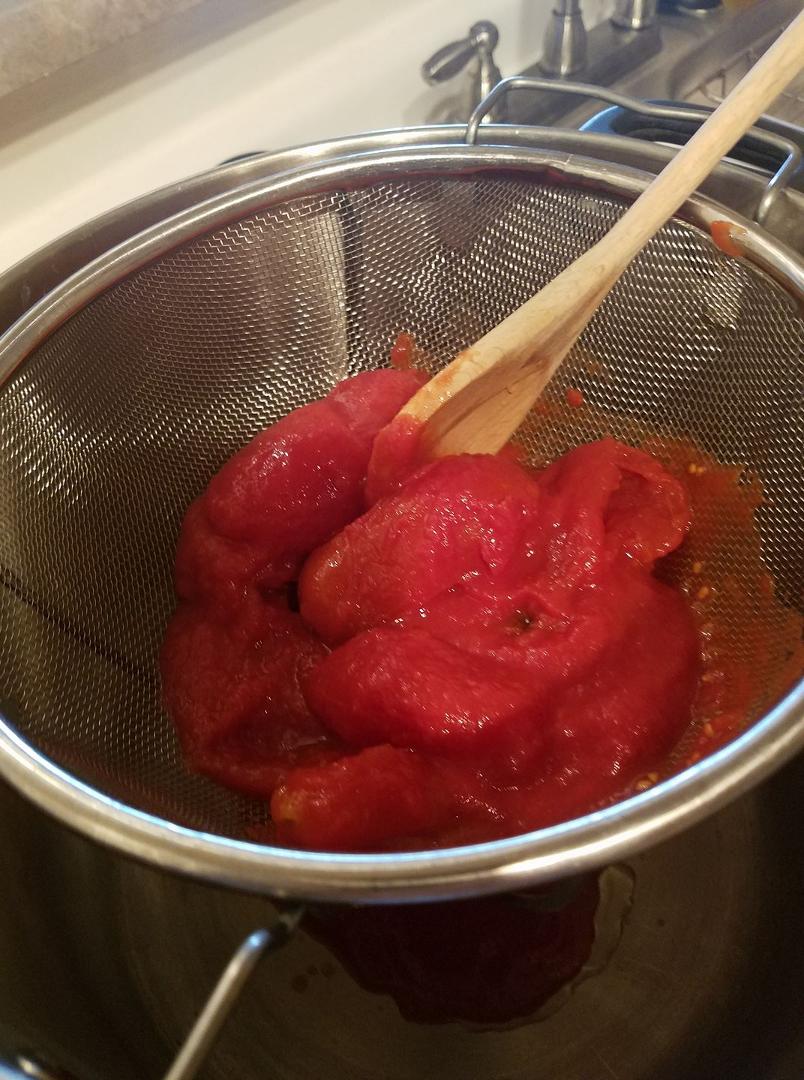 I am Hand crushing the San Marzano plum tomatoes to make my fresh sauce.... stay tuned!! Delisioso!!