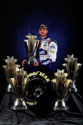 HOMESTEAD, FL - NOVEMBER 21: NASCAR Champion Jimmie Johnson, driver of the #48 Lowe's Chevrolet, poses with the Sprint Cup Series Championship trophies at Homestead-Miami Speedway on November 21, 2010 in Homestead, Florida