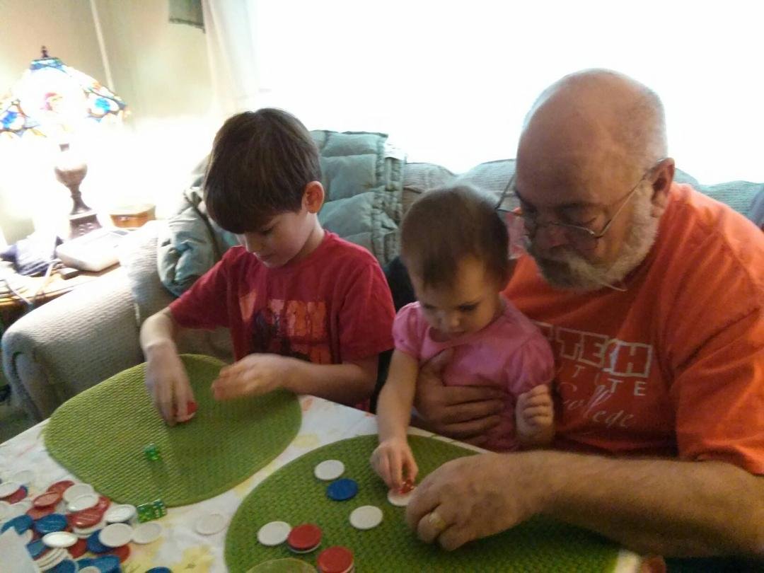 Edward, Elizabeth, and Grandpa with playing with chips!