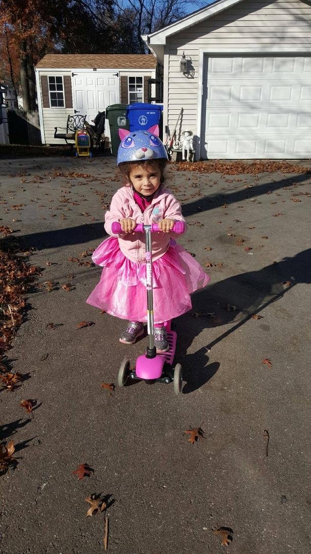 Athena riding Ashley's scooter