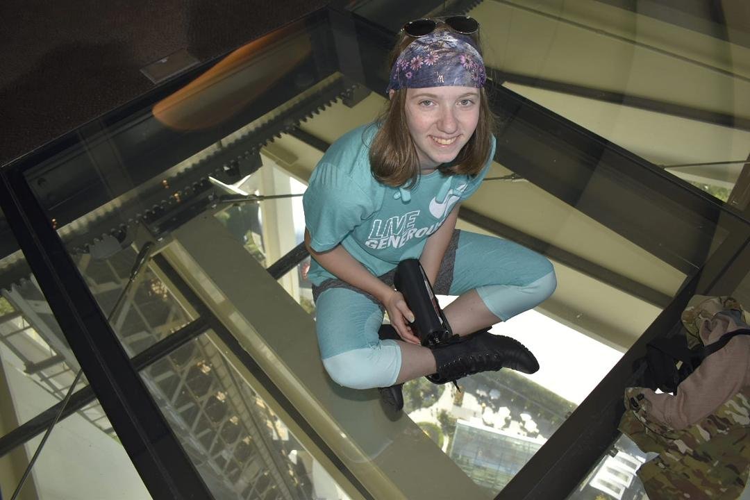 Abigail sitting on the rotating"glass floor"!