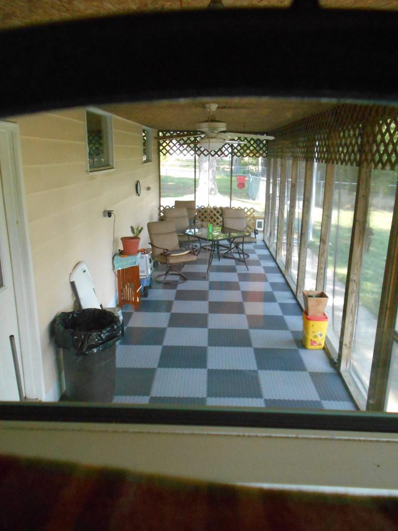 finished working on the deck floor on the screend in patio. Someone had painted it years before and the paint was looking bad. liked this idea better 1/4 in thick garage flooring tiles.