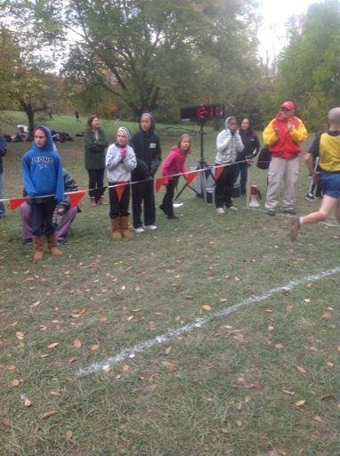 Grant as he crosses the finish line in first place. This was his last cross country race of 8th grade.