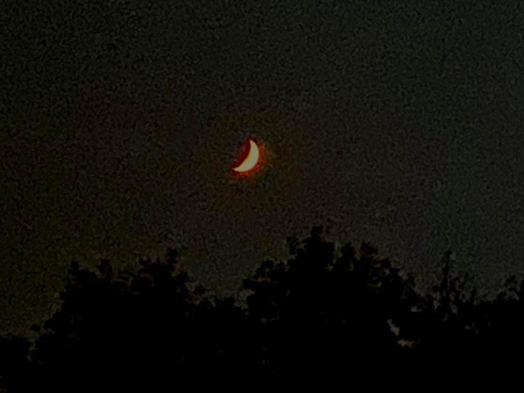 I wonder why the crescent moon is orange, tonight.