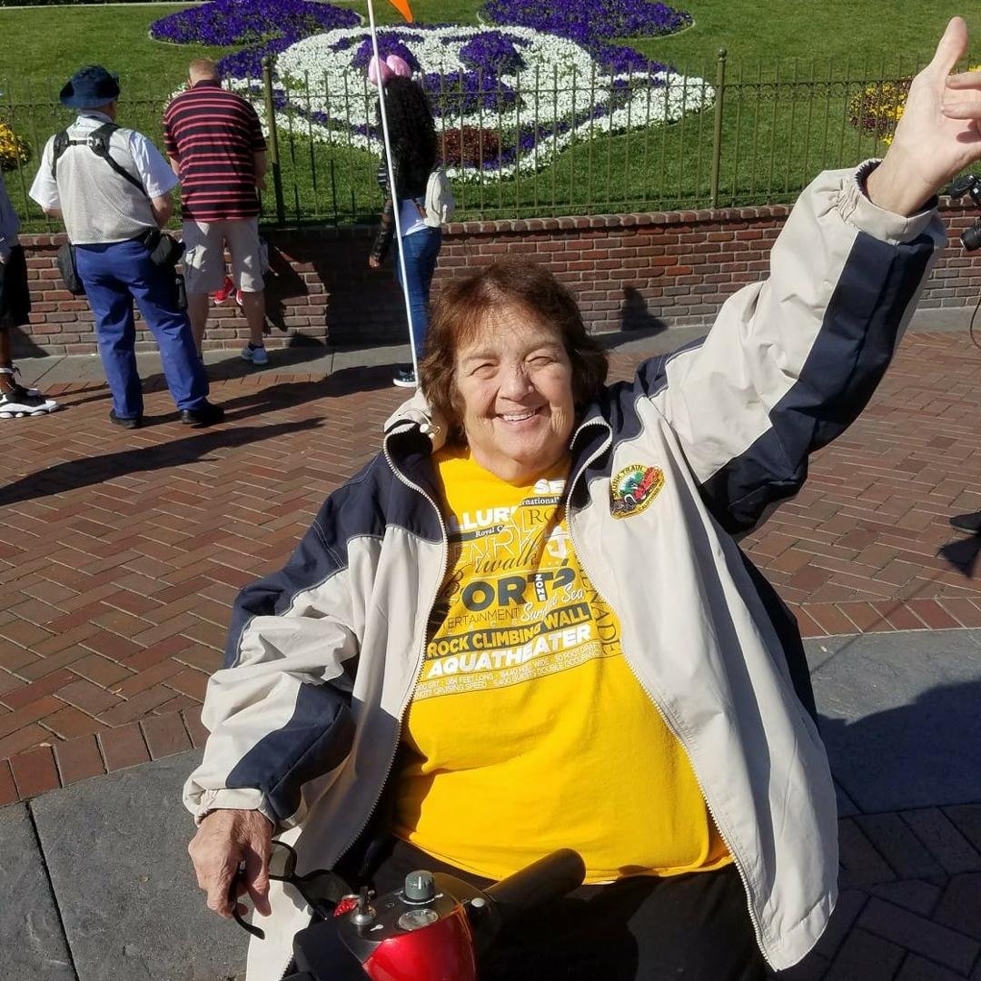 Linda waving at the happiest place. Great weather.