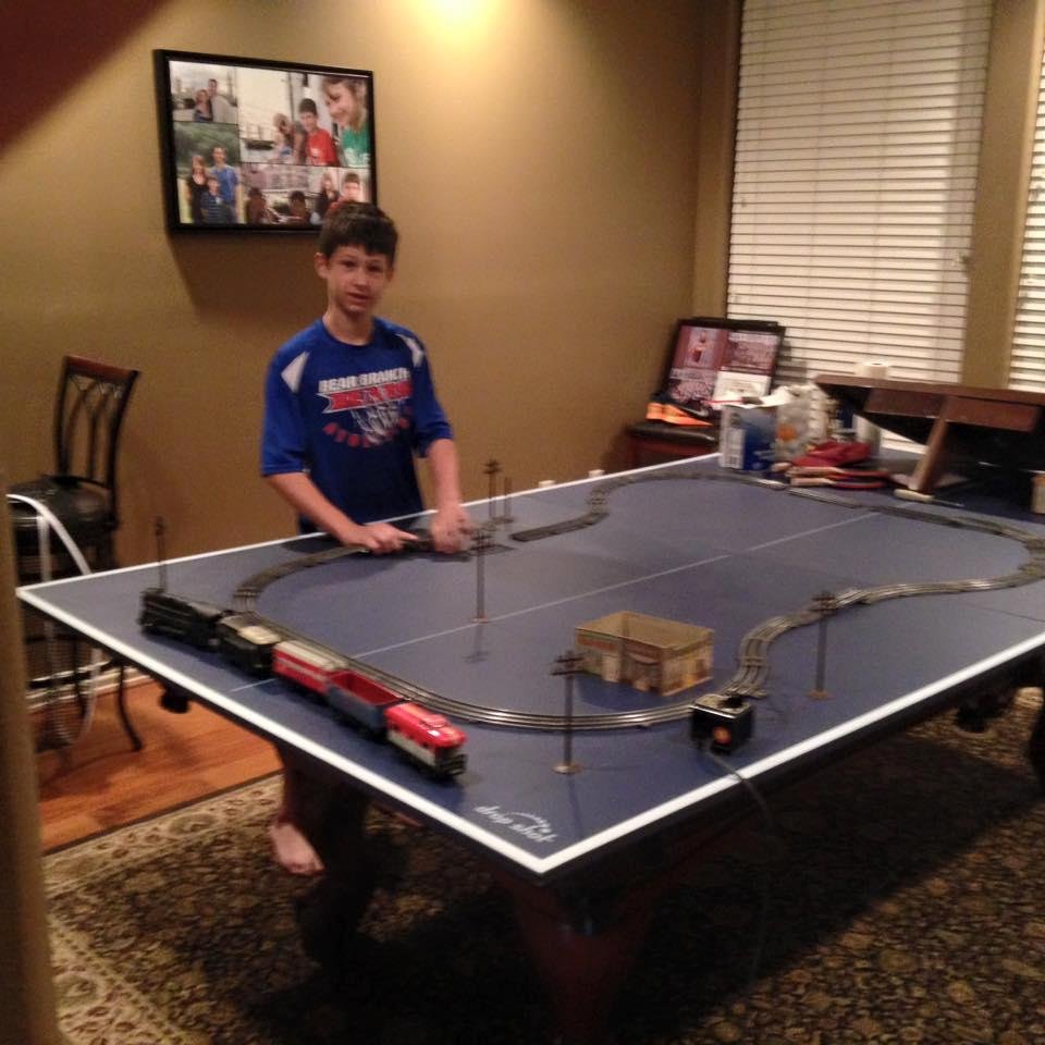 Our Grandson Andrew in Texas putting together Papa's 60 year old train and it still works