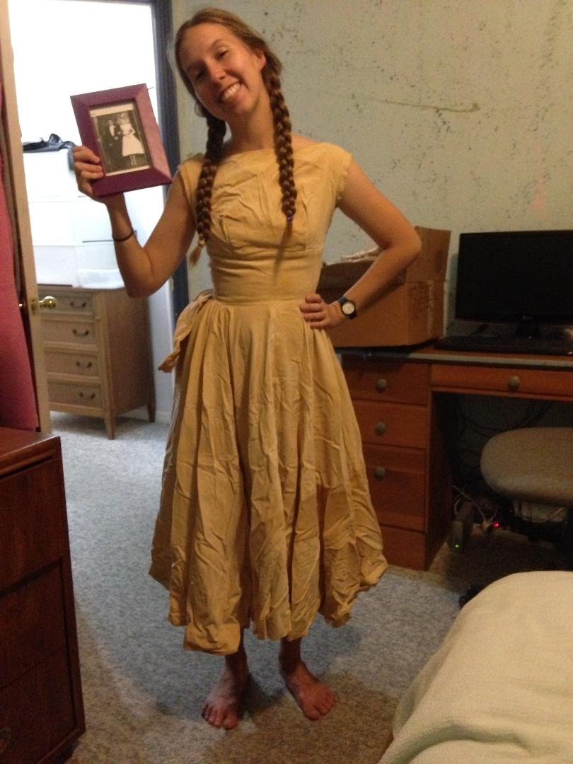 David found a box in my attic. Among the many things was my wedding dress. Bailey is wearing the dress and holding a picture of my wedding photo.