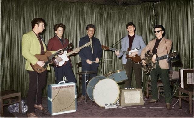 This colorized photo of The Beatles looks strange. It makes them all look like wax figures. And then where's Ringo? What did they do with Ringo? And who's that other guy on guitar? You always hear about the fabled "fifth Be