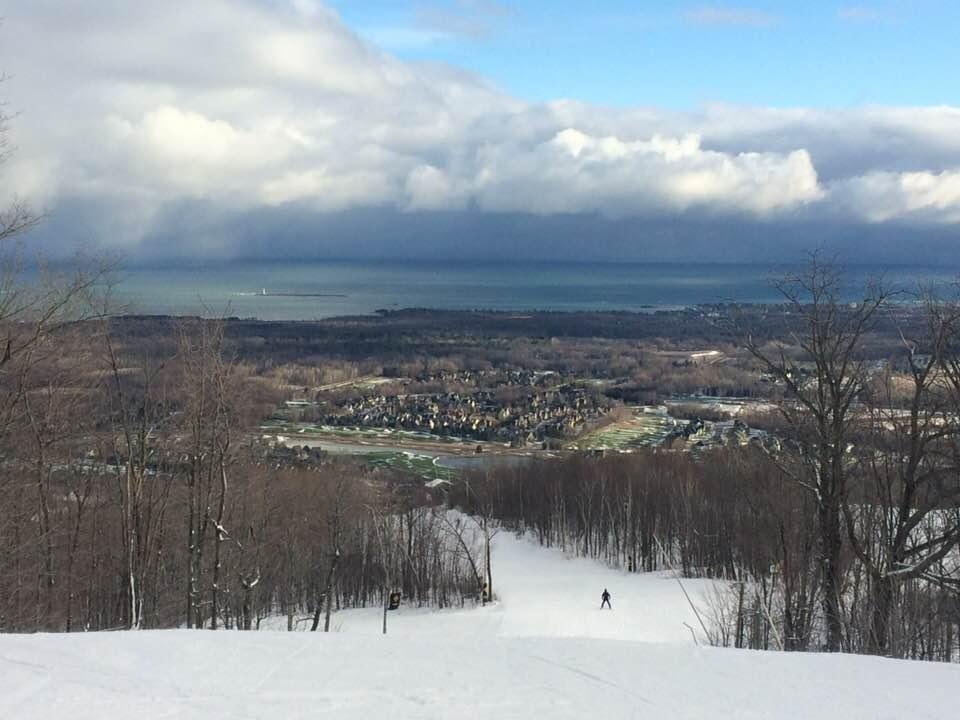 White slopes , green fairways and a multi blue bay