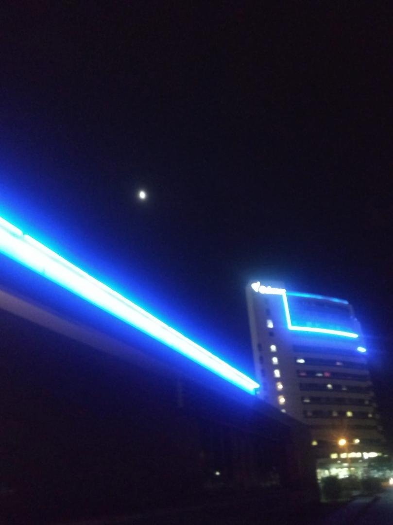 Half of moon sitting above Ochsner