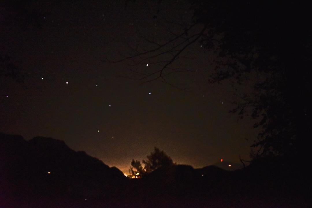 You have to appreciate modern cameras to find anything interesting in this photo. Pure darkness on the grounds of the Berghof, shooting up at the Big Dipper. That's Berchtesgaden lit up in the foreground. FB loses much d