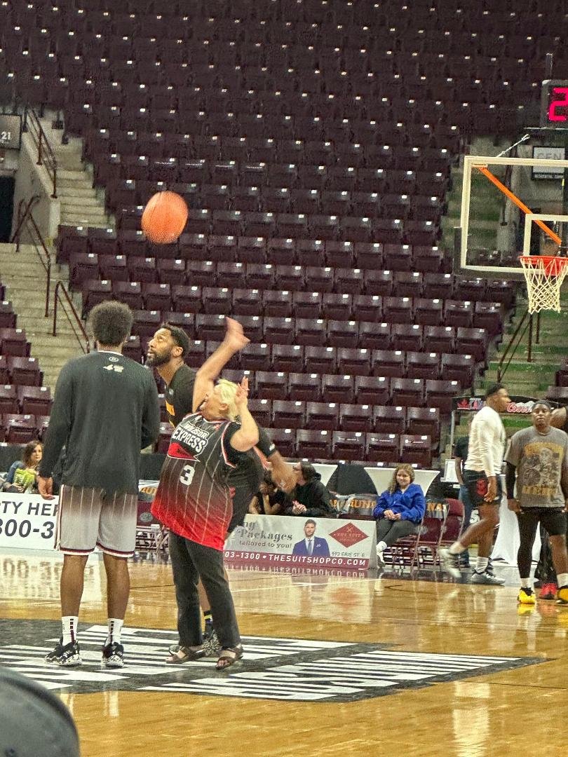 Lois is making a three point shot from centre court.