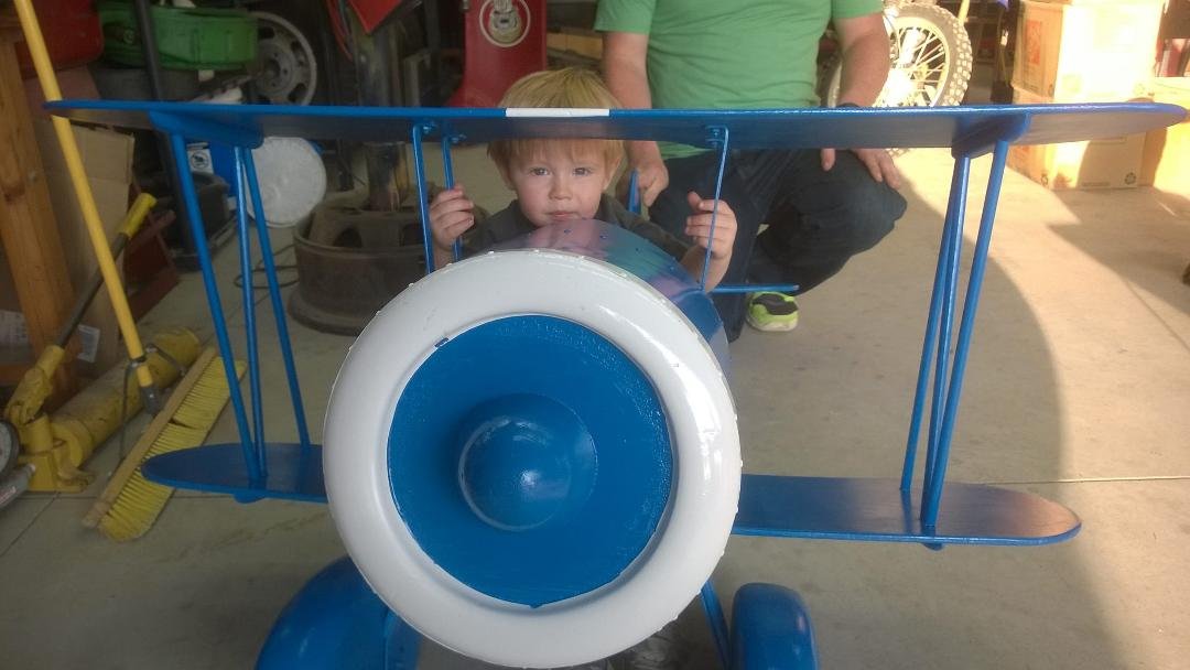 Colton in the plane great grandpa built for dad.