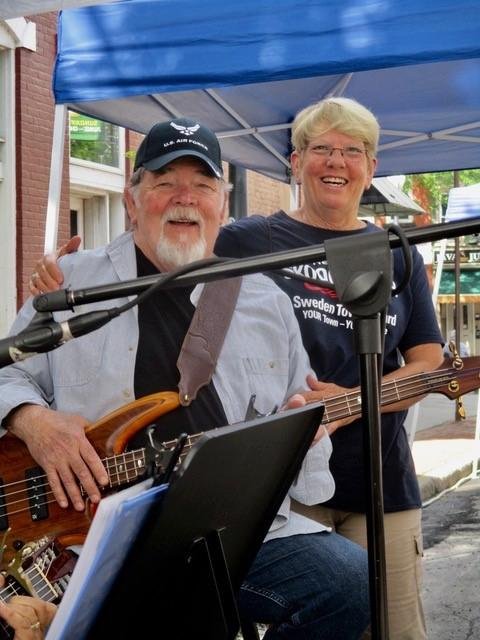 A friend stops to visit while I'm performing with She Sings at Brockport Farmers Market
