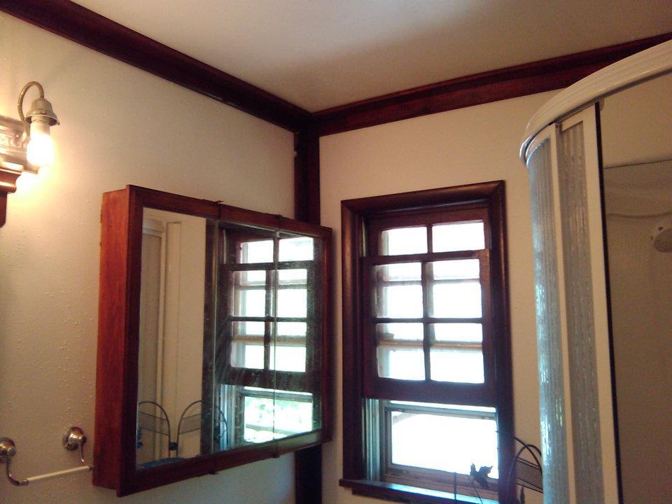 New bathroom, with a new corner shower with semicircle shower door, new walls, and ceiling.