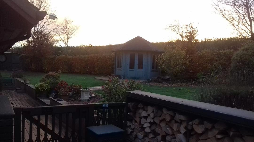 Autumn sunrise over our Summer house this morning (Logs are ready for winter)