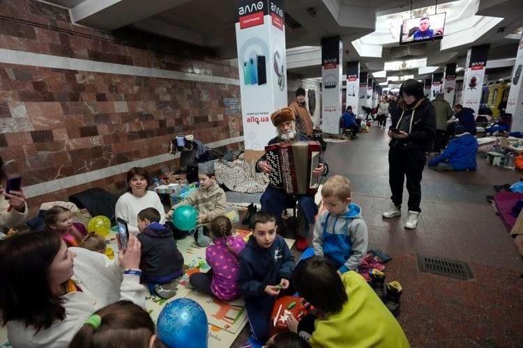 Today in Kiev, Ukraine, the elderly man playing the accordion is bringing some little joy to the children, and families living in a subway. War times are haunting for the young, and elderly, plus the fathers are away fight