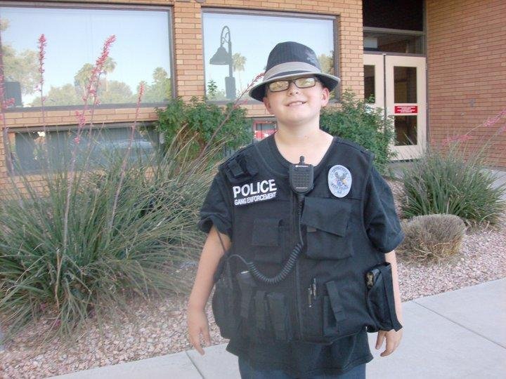 Cop put vest on Tyler for school project! I think this cop was hitting on me! :) He was cute ;)