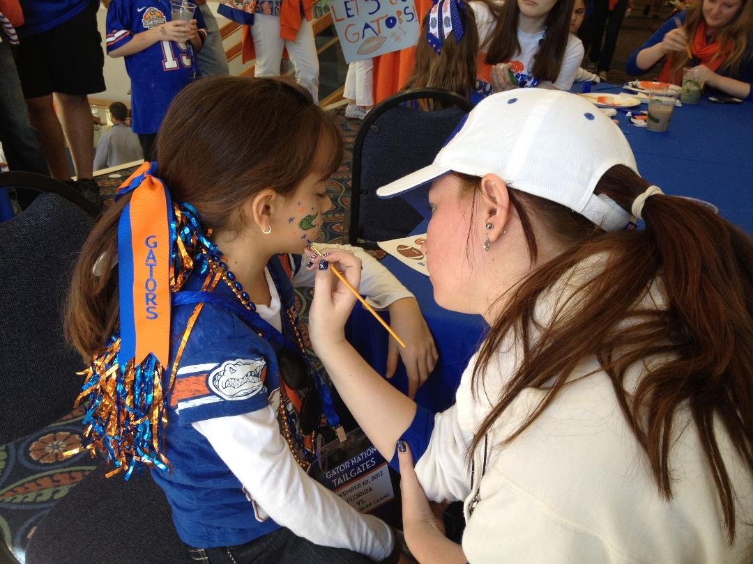 Traci at the Gator game doing face painting.