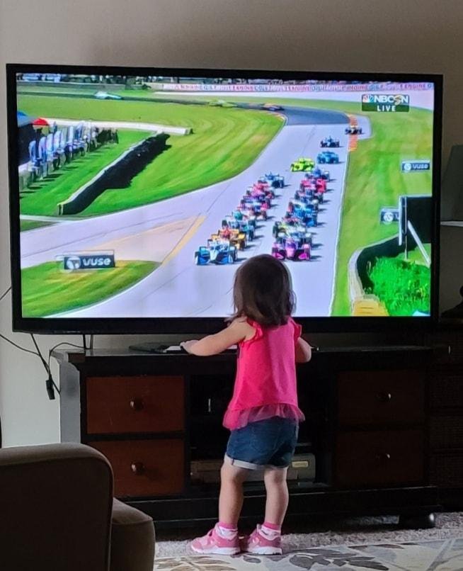 My granddaughter watching Indy Car.