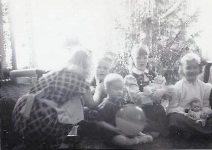 Mom straightening brother Bernie's tie - Christmas 1947. Bernie, Joyce, Carol and Johnny