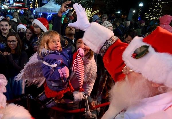 Santa waves at the crowd.