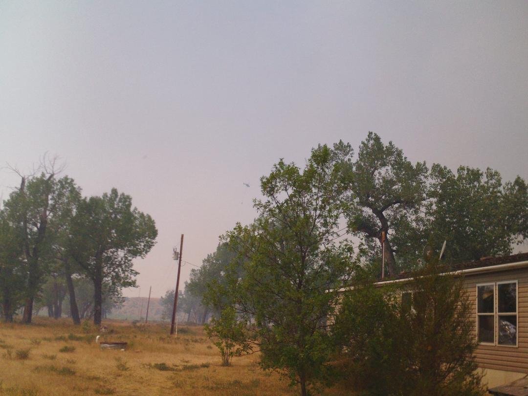 Helicopter flying by every few minutes to get a bucket full of water from the river to dump on the fire 1/2 mile away.