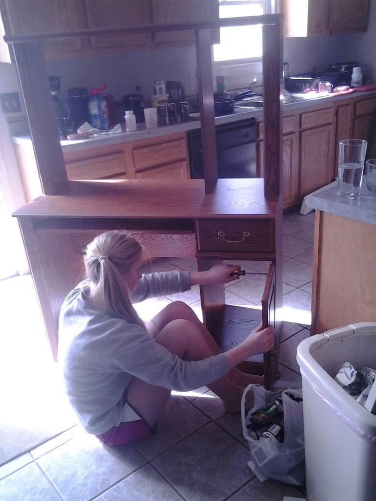 My daughter helping me put together our new computer desk