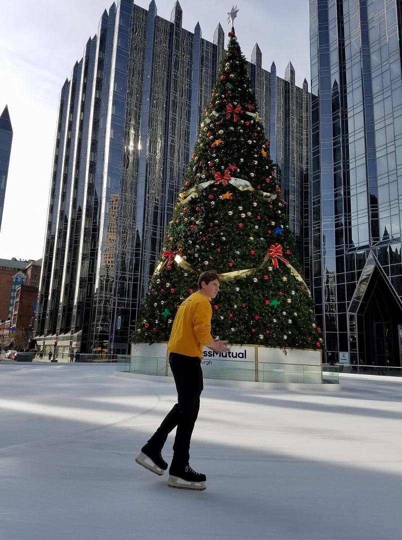 Skater at the PPG ice rink and Pittsburgh's Christmas tree.