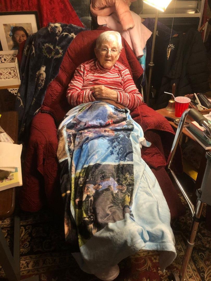 My Mom is now 98 years old. She is coming up on her 99th Christmas. The blanket on her lap just arrived from the family of her Grandson, Tim Heck, with pictures of his family printed on it. She said its nice and warm and ha