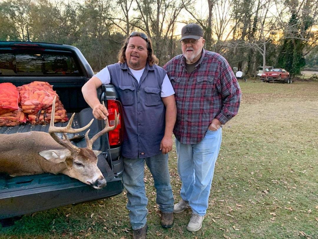 Chuck Simmons and Charlie Simmons with one dead deer