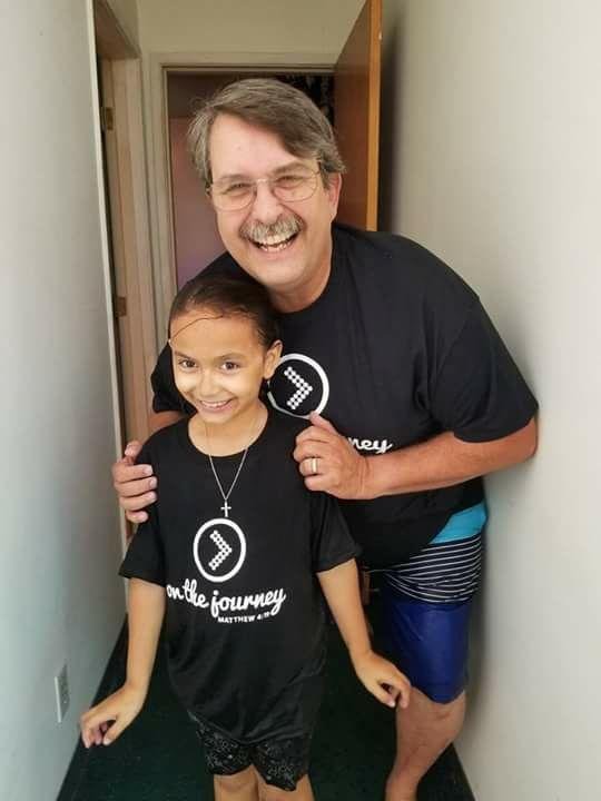 My grandaughter Kaydee with grandpa getting baptized. .