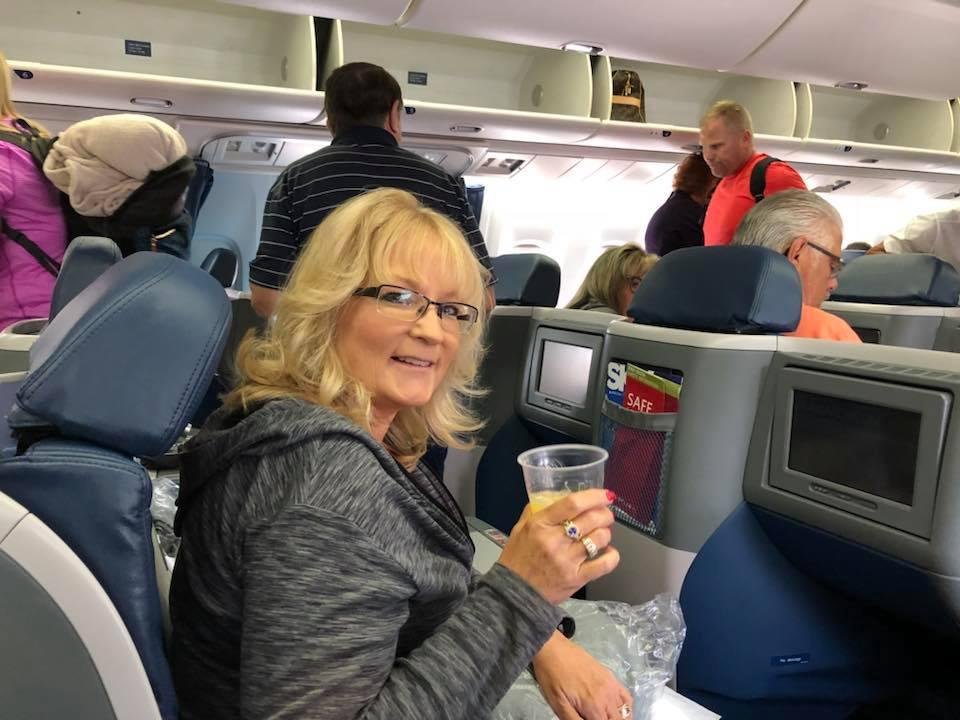 Boarding for our final flight and Lisa Is already up one mimosa!