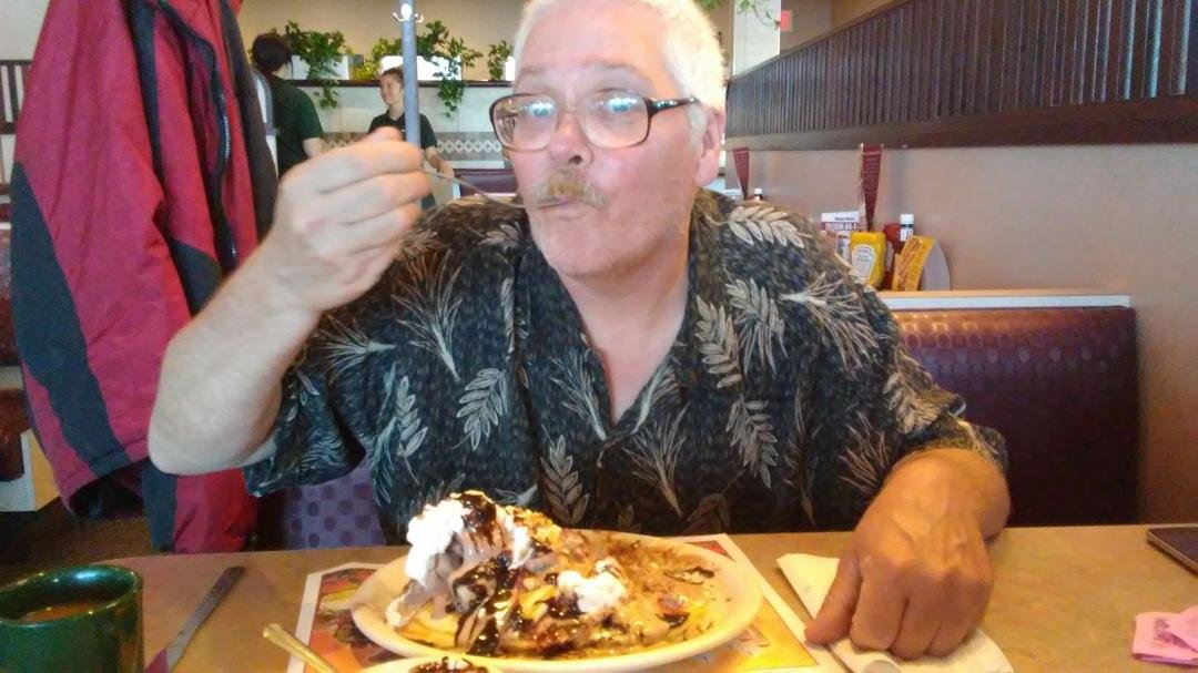 Gary eating banana split pancakes at Ram's Horn