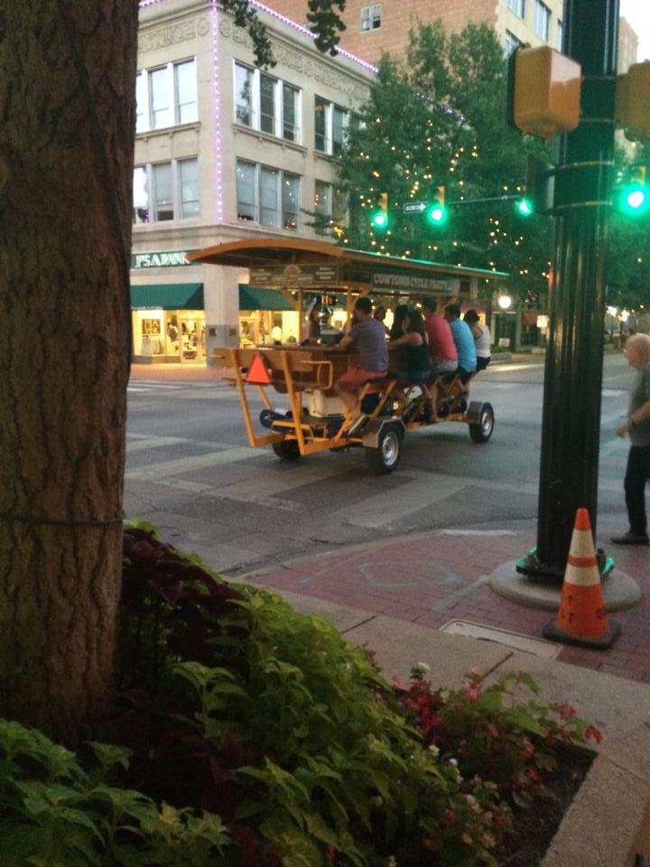 Downtown Fort Worth, TX on Friday evening, watching the "Bar on Wheels" that is peddle powered as it zips down the block.