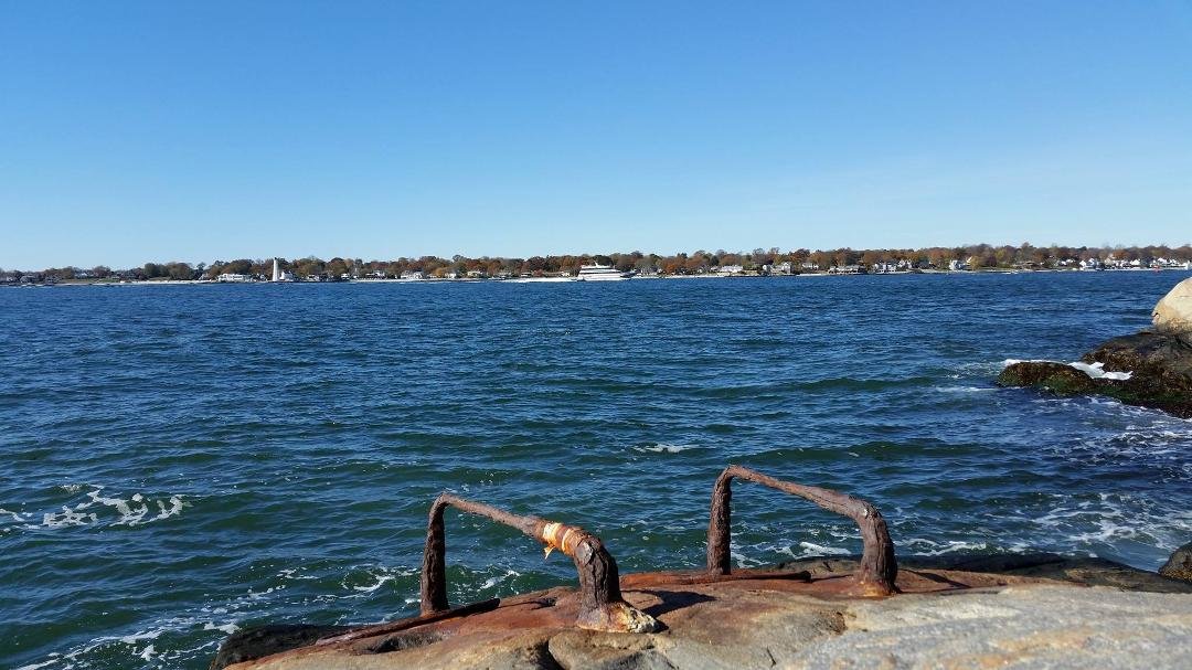 From Eastern Point Beach with the brackets and rings for the old anti-submarine net. Sea Jet coming in from Orient Point just passed the New London Harbor Light.