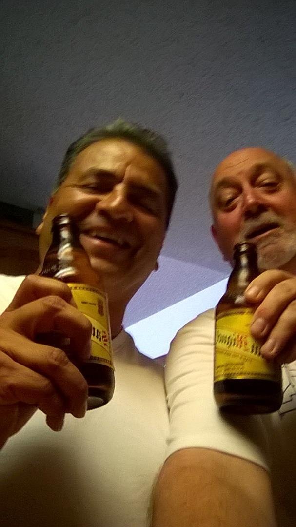 Friends meet first time in 32 years... Stationed together in the Philippines... Celebrating with a San Miguel
