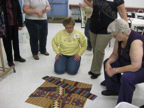 Friendship quilt - a background and then four gals each make a strip and then piece them over top of the background